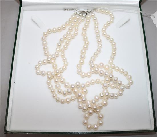 A triple strand cultured pearl necklace with silver clasp. A double row South Sea cultured pearl necklace, 51cm